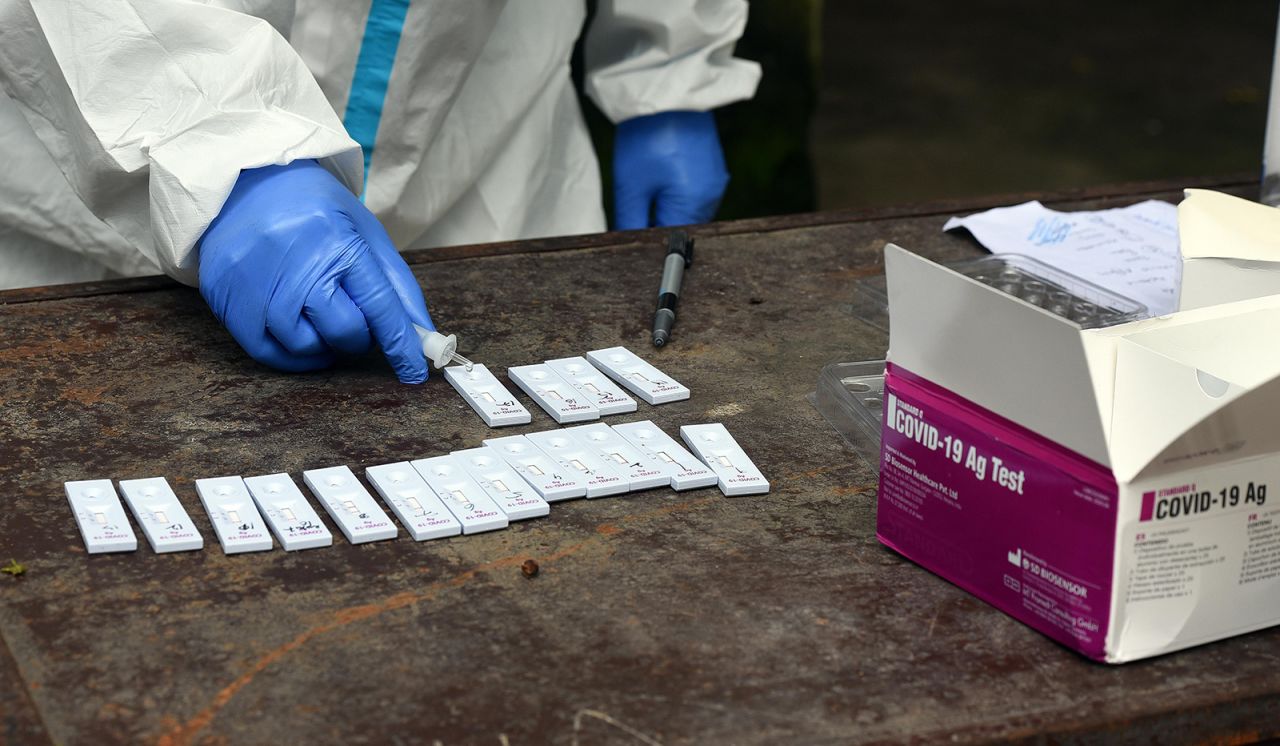 A health worker conducts a coronavirus rapid antigen test from collected swab samples in New Delhi, India.