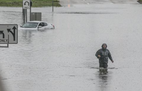 A man walks through the flooded feeder roads off of Highway 69 North on Sept. 19, 2019 in Houston, Texas. 