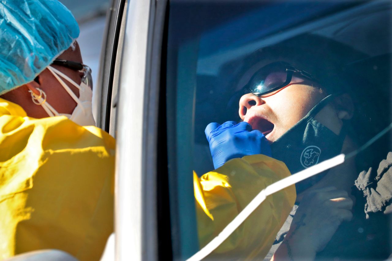 People get tested for COVID-19 at a drive through testing site hosted by the Puente Movement migrant justice organization on June 20 in Phoenix. 