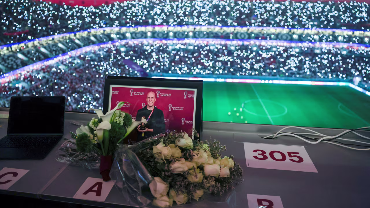 Flowers and a picture of the journalist Grant Wahl are seen in the media room during the World Cup match between England and France on Saturday.