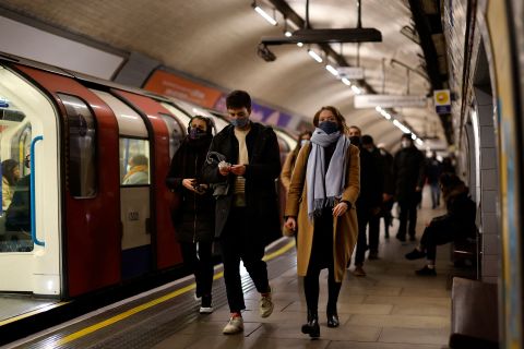 Passengers wear face masks as they travel on the London underground on Sunday, November 28. 