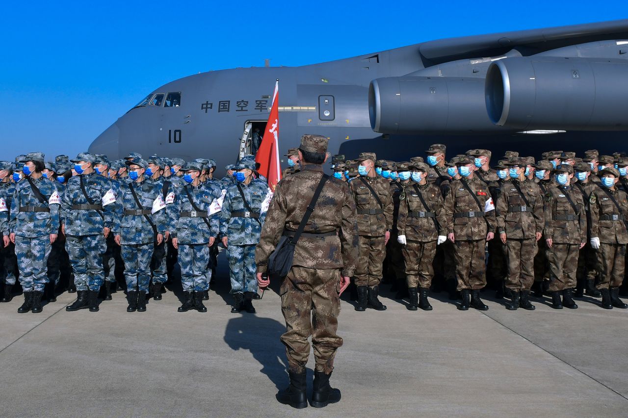 In this photo released by Xinhua News Agency, military medics stand in formation as they arrive at Tianhe International Airport in Wuhan in central China's Hubei Province on February 17. 