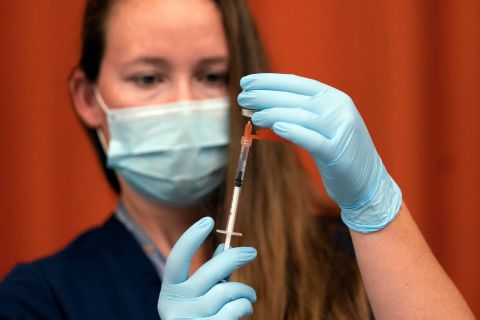 Katrina Taormina draws the Pfizer COVID-19 vaccine into a syringe at Lehman High School in New York on July 27.