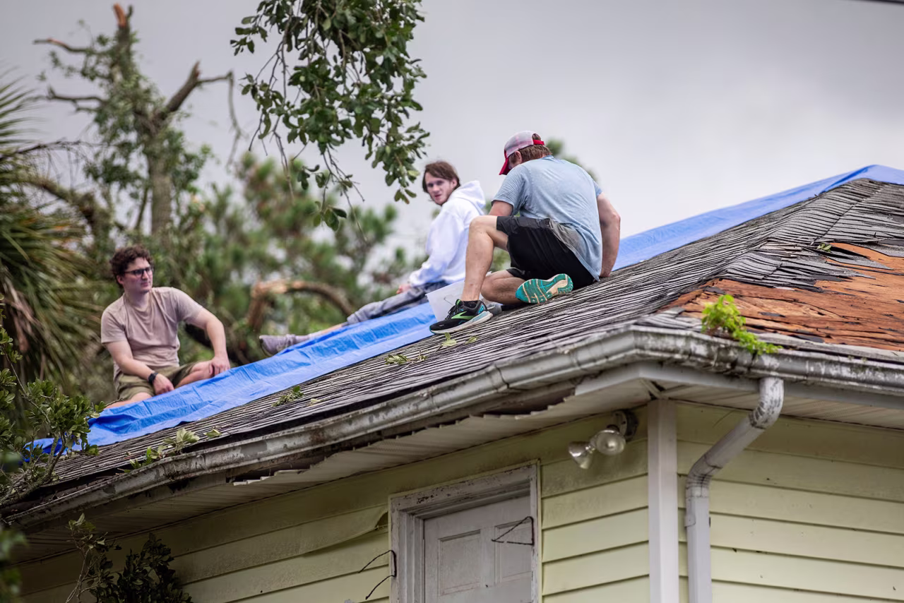 Residents repair their roof as high winds from an outer band from Tropical Storm Debby passed over the Isle of Palms, South Carolina, on August 6.