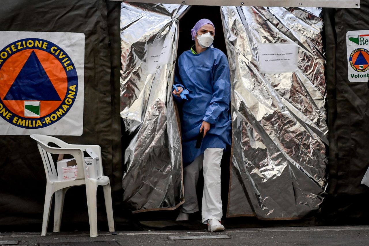 A paramedic wearing a mask gets out of a tent set up by the Italian Civil Protection outside the emergency ward of the Piacenza hospital in northern Italy on Thursday, February 27. 