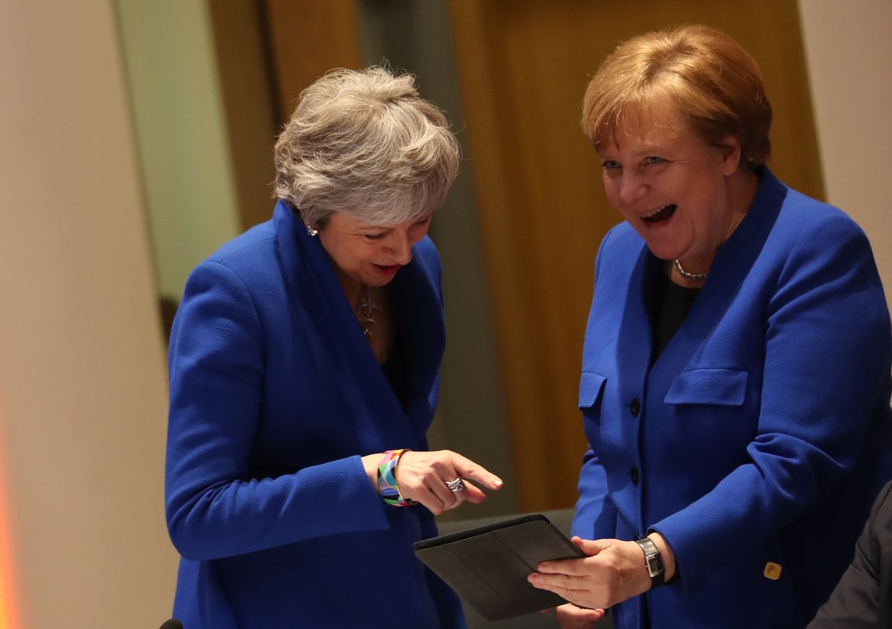 May and Merkel share a laugh at the EU Council summit.