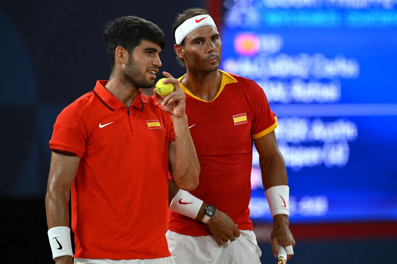 Spain's Carlos Alcaraz, left, and Rafael Nadal speak while playing the United States' Austin Krajicek and Rajeev Ram on Wednesday.