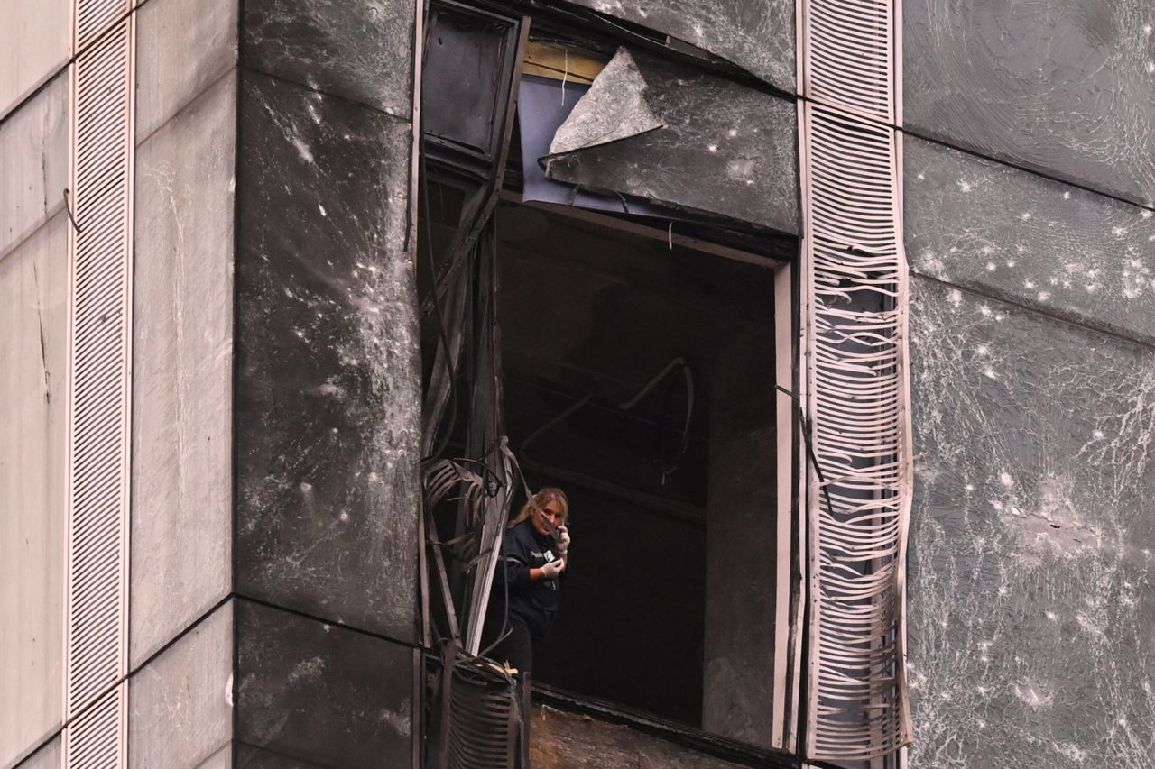 A woman inspects the damage sustained to a building at the Moscow International Business Center following a drone attack in Moscow, Russia, on August 23.