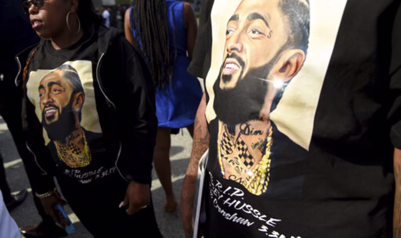 Guests wear T-shirts in tribute to Nipsey Hussle at the late rapper's memorial service on Thursday at the Staples Center in Los Angeles. 