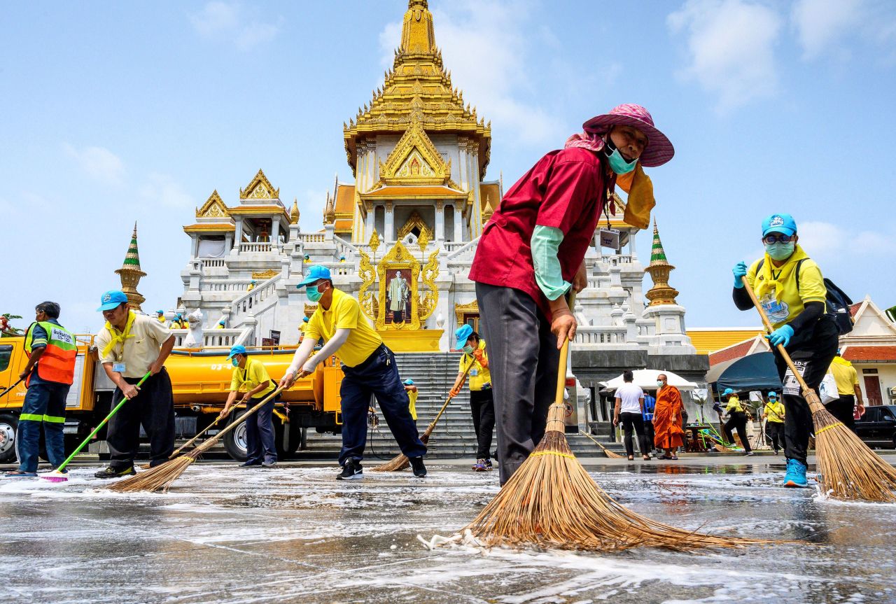 Volunteers use disinfectant Wat Traimit temple in Bangkok, Thailand on March 18.