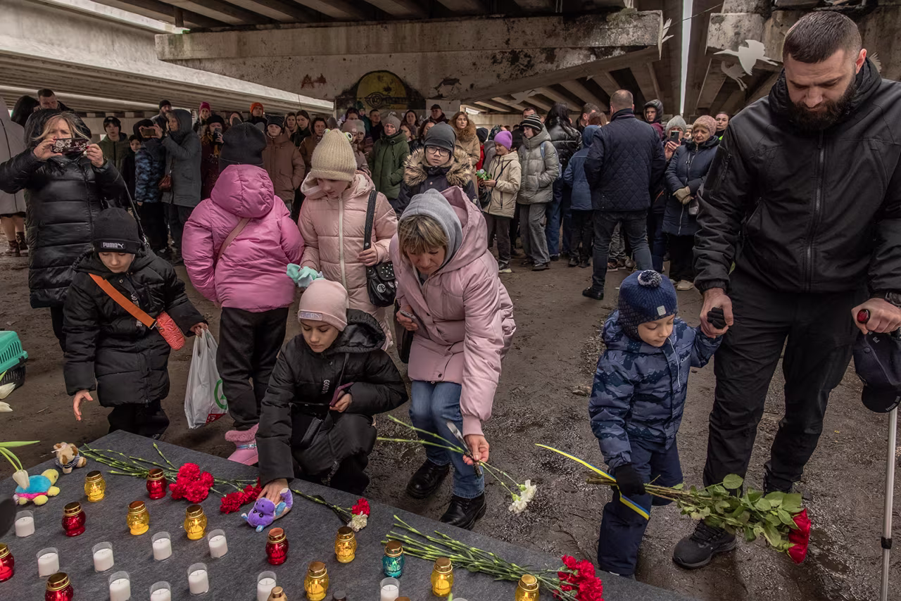 Residents attend a memorial in Irpin, Ukraine, on February 24.