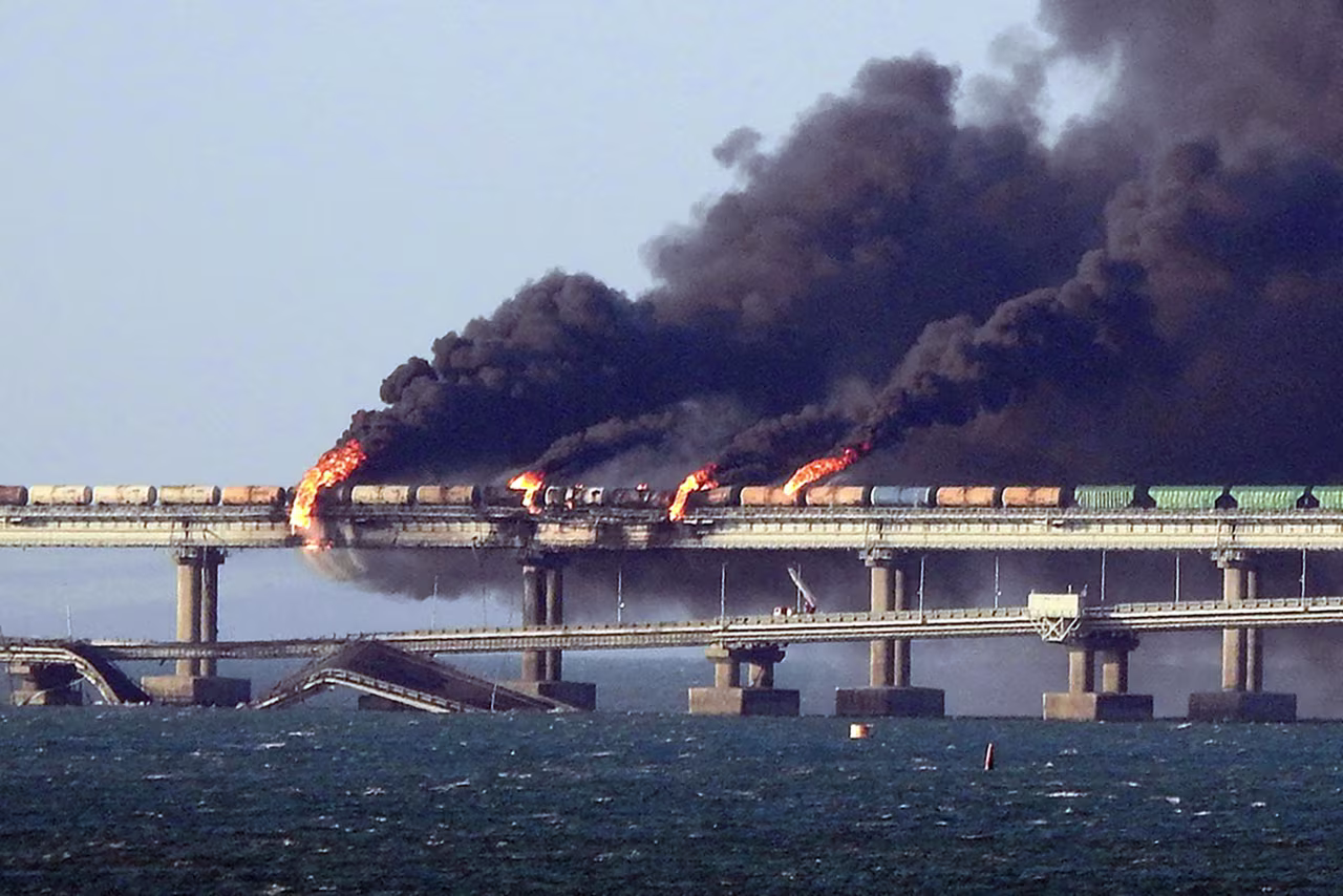 Black smoke billows from a fire on the Kerch bridge that links Crimea to Russia, after a truck exploded, near Kerch, on October 8, 2022.