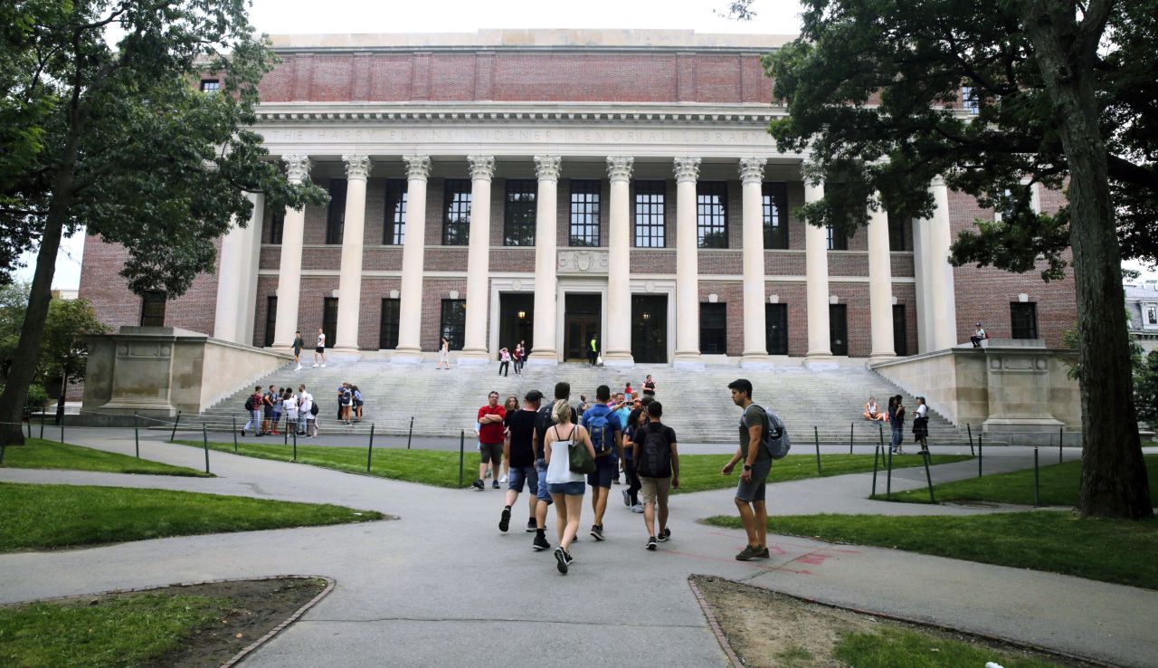 Students walk near the Widener Library in Harvard Yard at Harvard University on August 13, 2019.