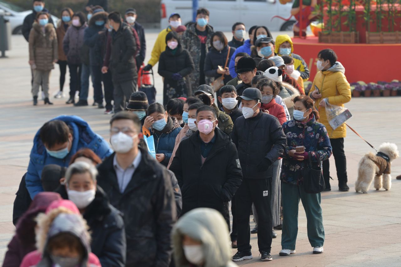 People line up outside a drugstore to buy medical masks in Nanjing, China, on Wednesday, January 29.