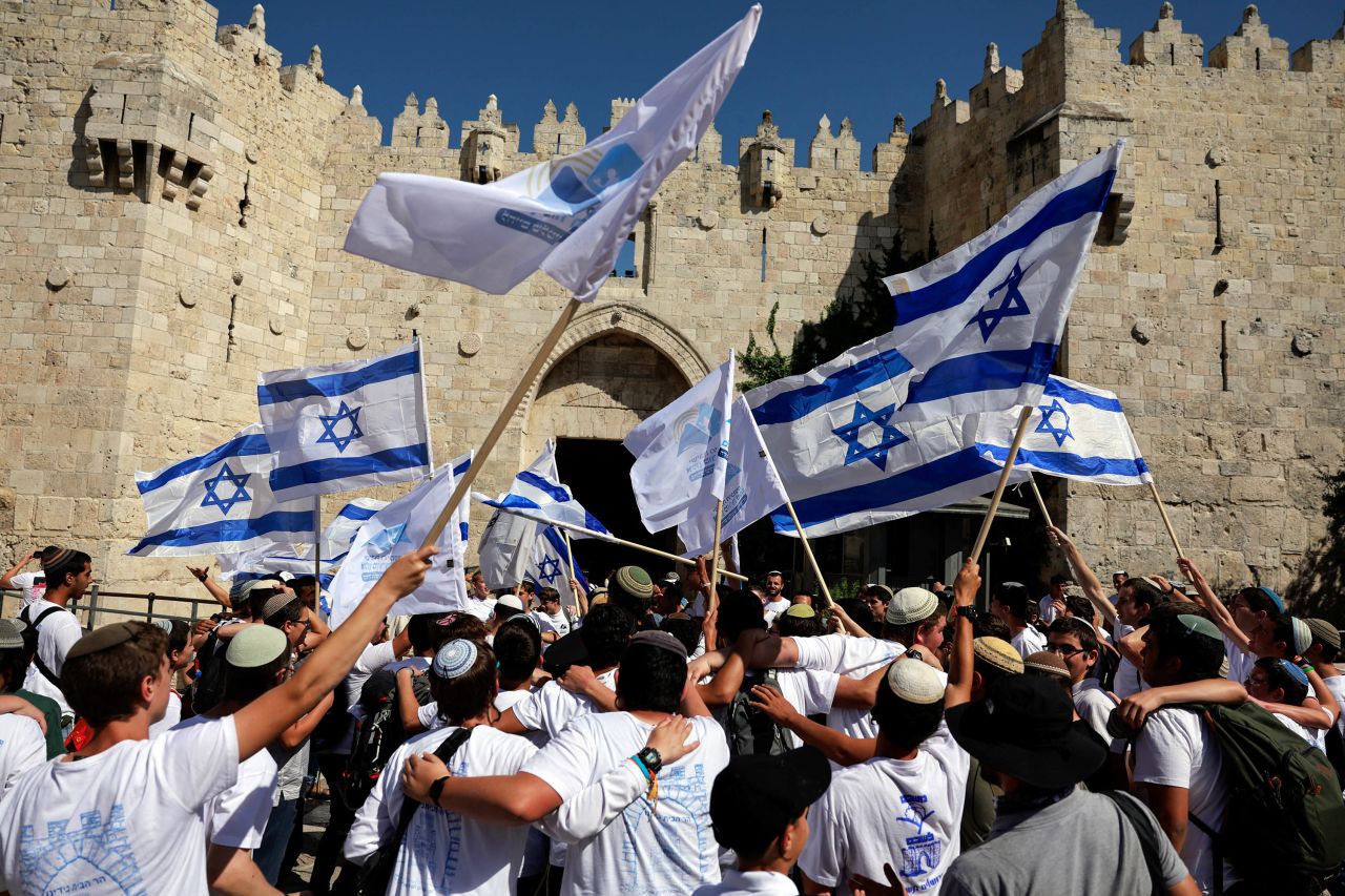 Israelis hold flags as they make their way towards Damascus Gate for the annual Jerusalem Day march on June 5.