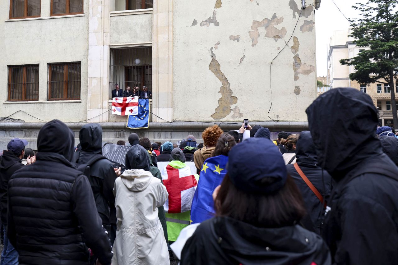 Georgia's opposition lawmakers hang Georgian and a European Union flags on the facade of the parliament building in Tbilisi on Tuesday.