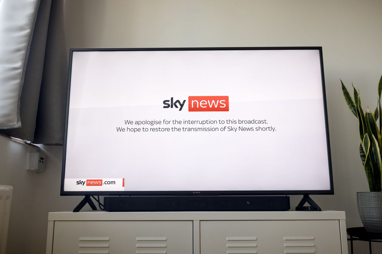 In this photo illustration a television screen displays a Sky News announcement of an interruption to this broadcast as the channel is off air due to an IT outage on July 19, in London, England.