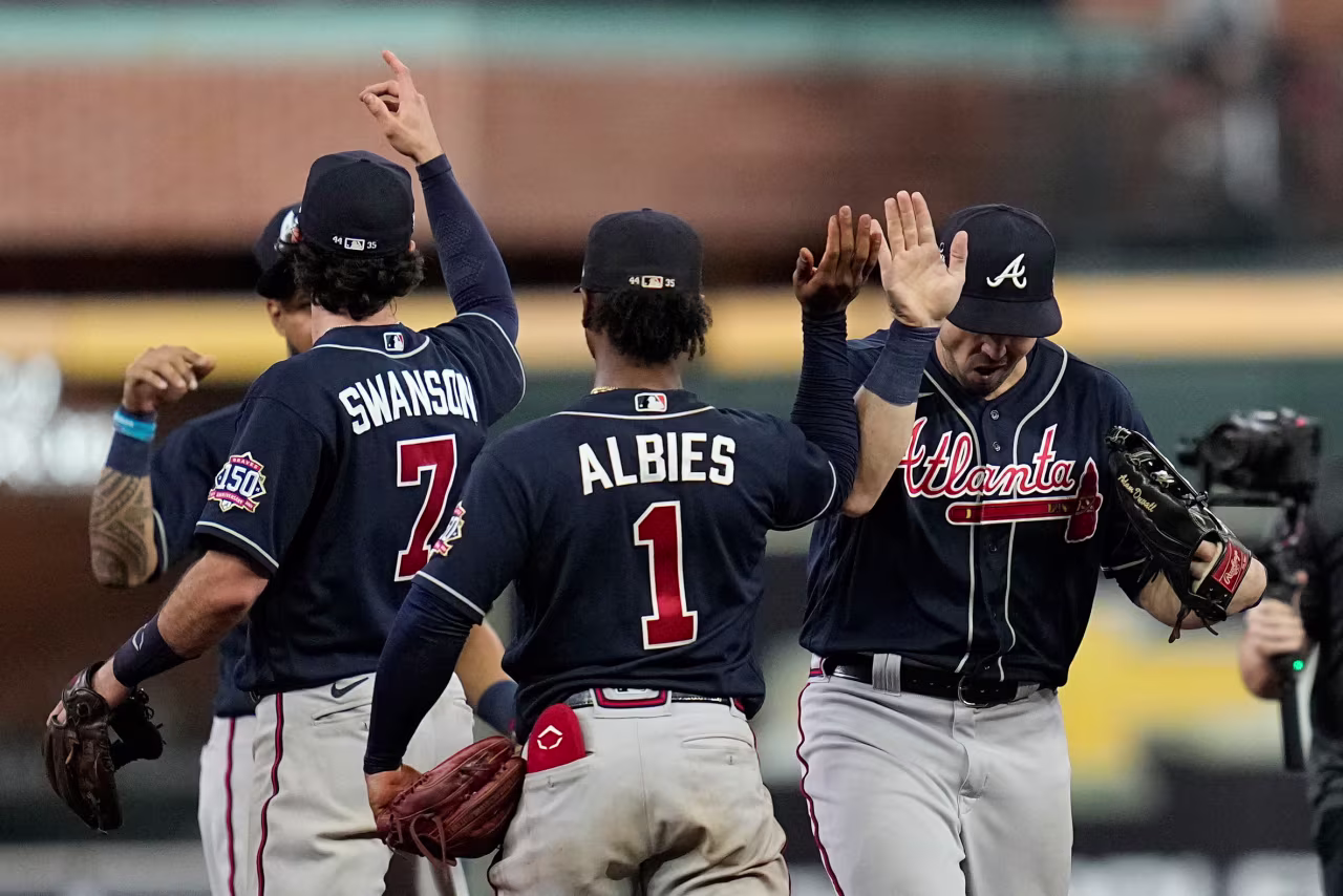 The Atlanta Braves celebrate their win against the Houston Astros in Game 1 of baseball's World Series on October 26 in Houston. 