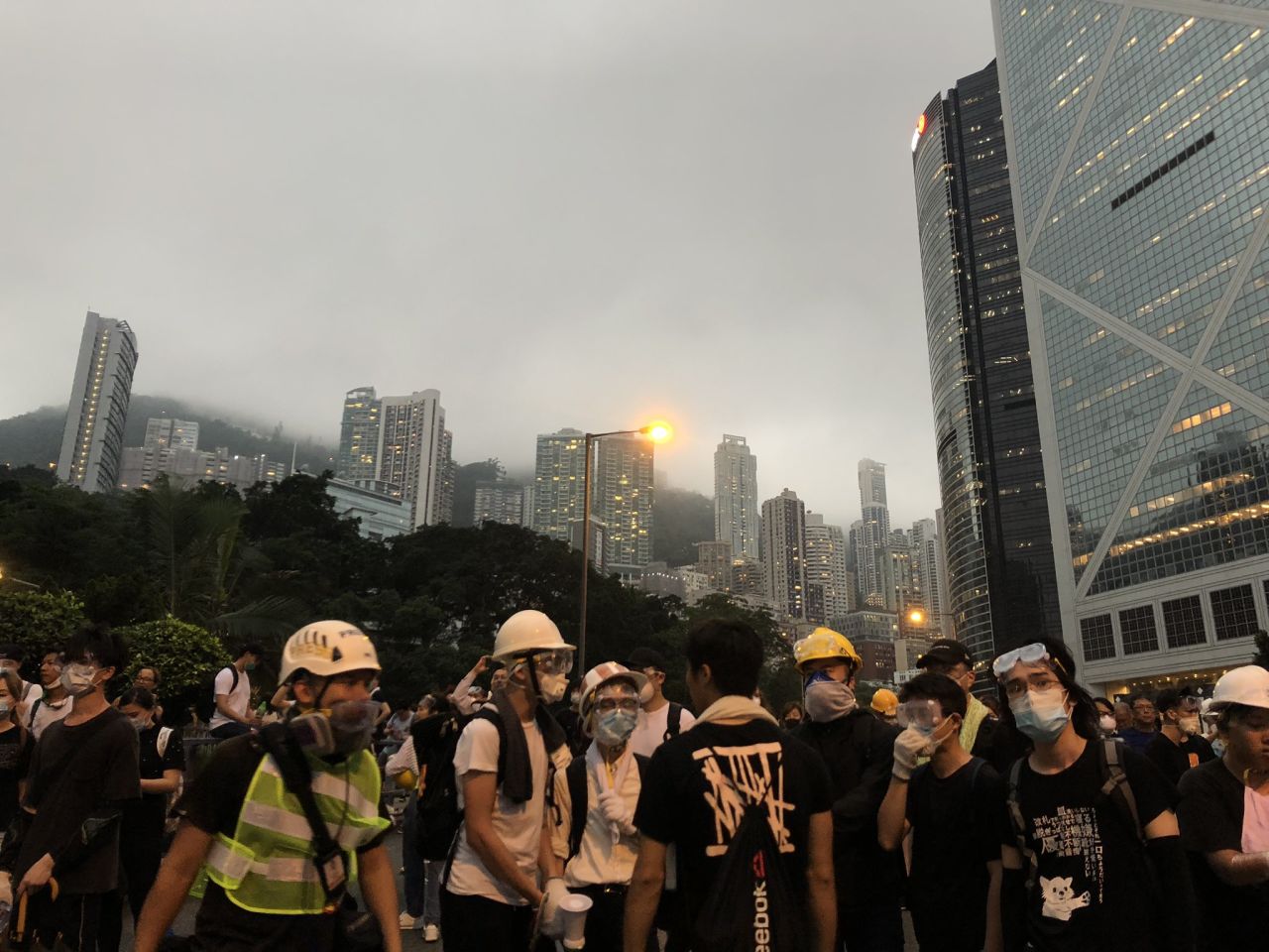 Protesters wearing masks and helmets on Cotton Tree Drive