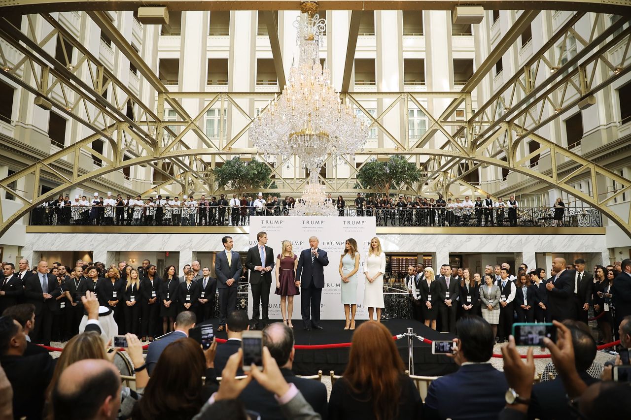 Trump (c) and his family prepare to cut the ribbon at the new Trump International Hotel in October 2016