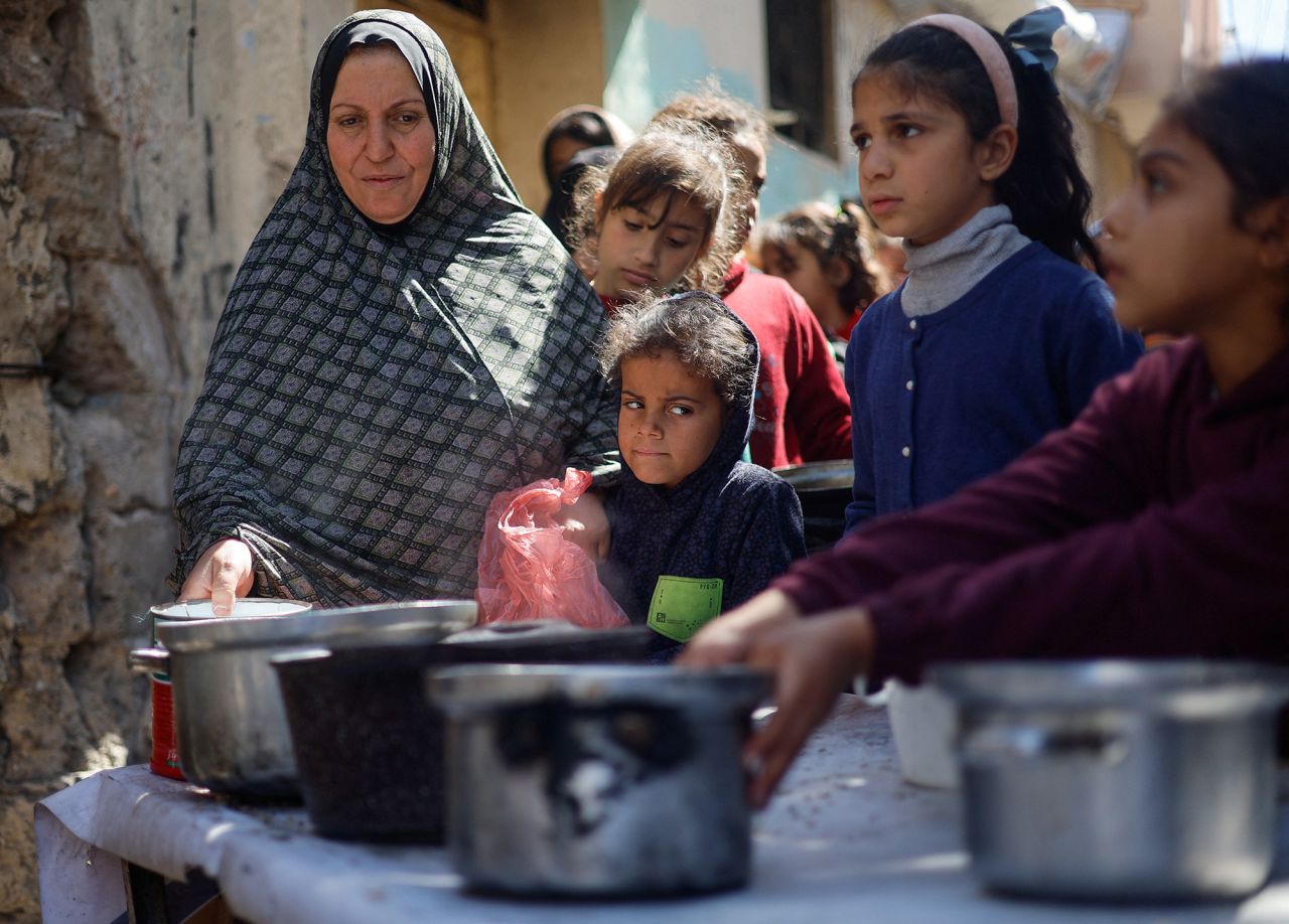 Palestinians wait to receive food cooked by a charity kitchen in?Rafah, Gaza, on March 5.