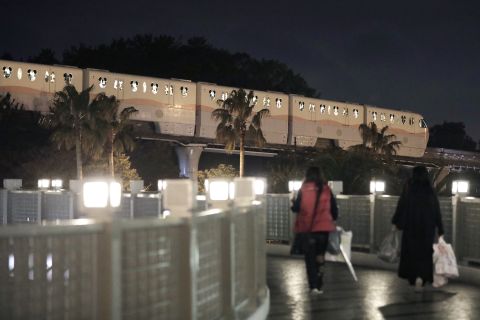 A Disney Resort Line train travels along an elevated track near Tokyo Disneyland at night in Urayasu, Japan, on March 2. 