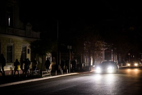 A car lights a street without electricity in Kyiv on October 31.