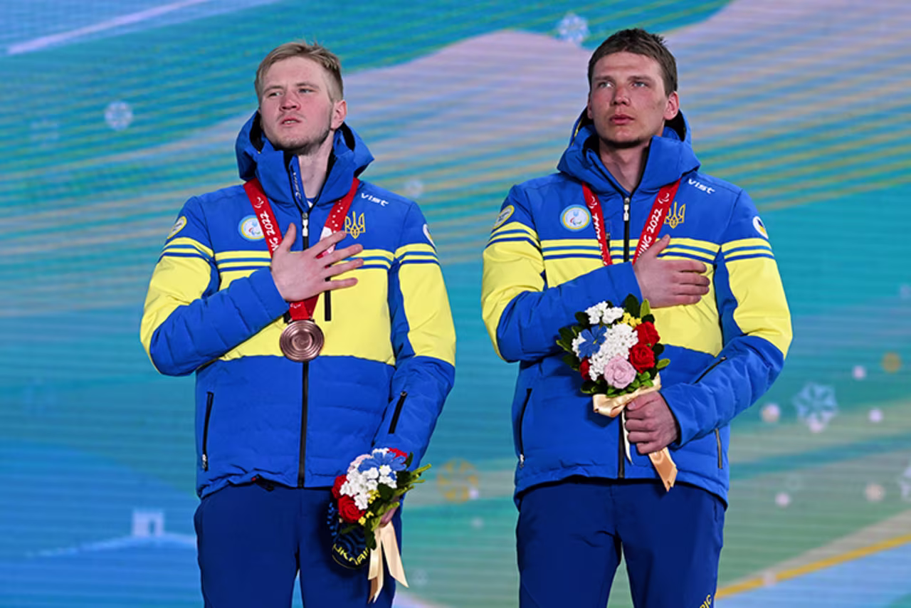 Bronze medallist Dmytro Suiarko of Team Ukraine, left, and guide Oleksandr Nikonovych celebrate during the Men’s Para Biathlon Middle Distance Vision Impaired medal ceremony on Tuesday, March 08, in Zhangjiakou, China.