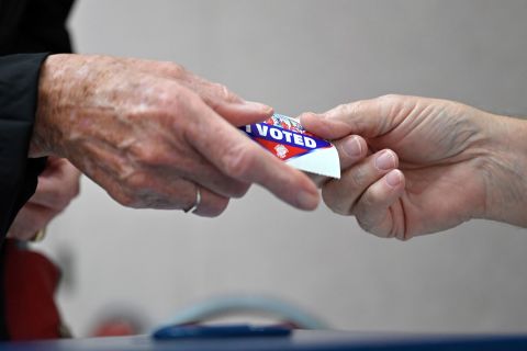 A voter receives an "I Voted" sticker after casting their ballot on the first day of in-person early voting in Las Vegas, Nevada on October 22. 
