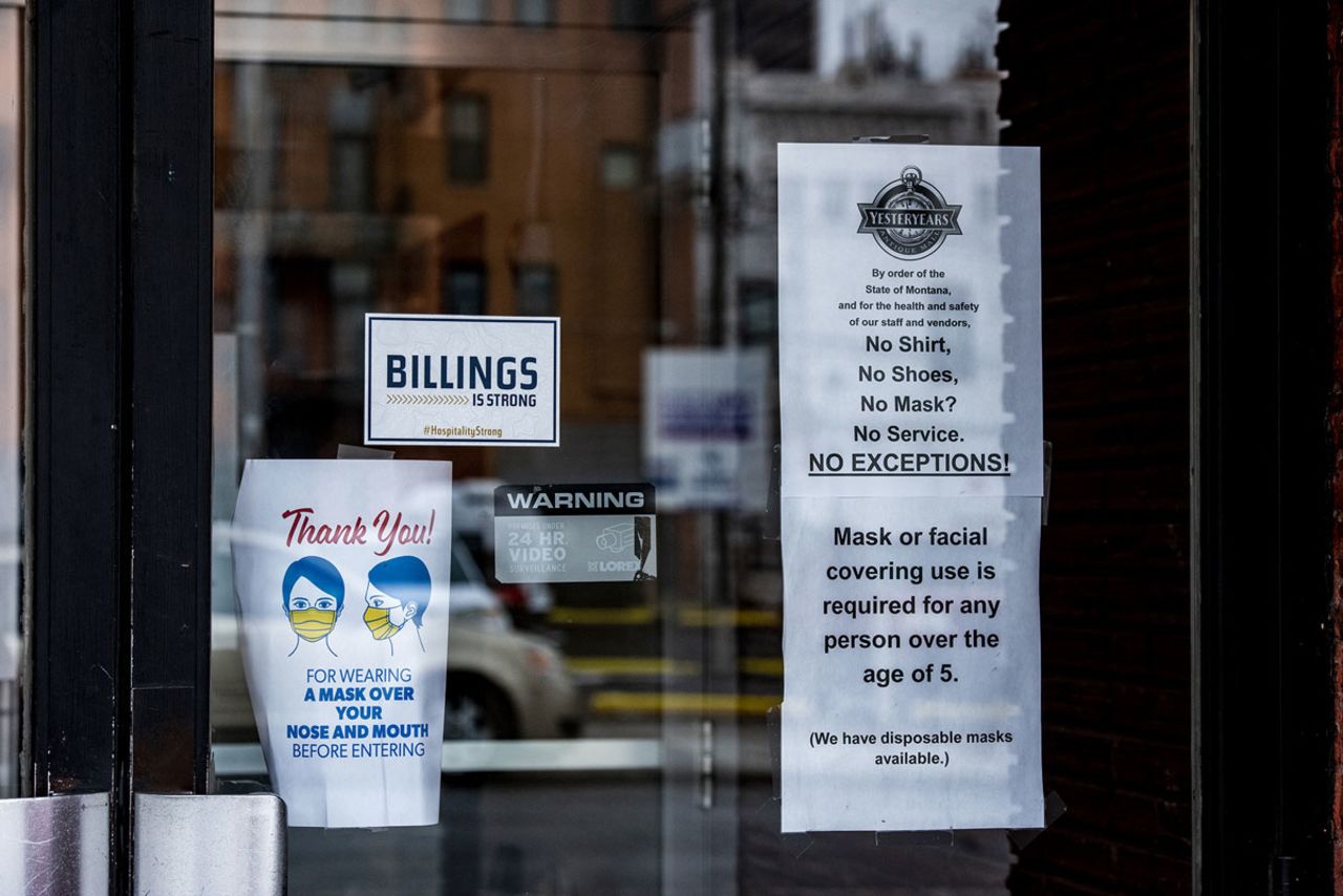 A sign requiring masks is seen outside a store in downtown Billings, Montana on November 11, 2020.