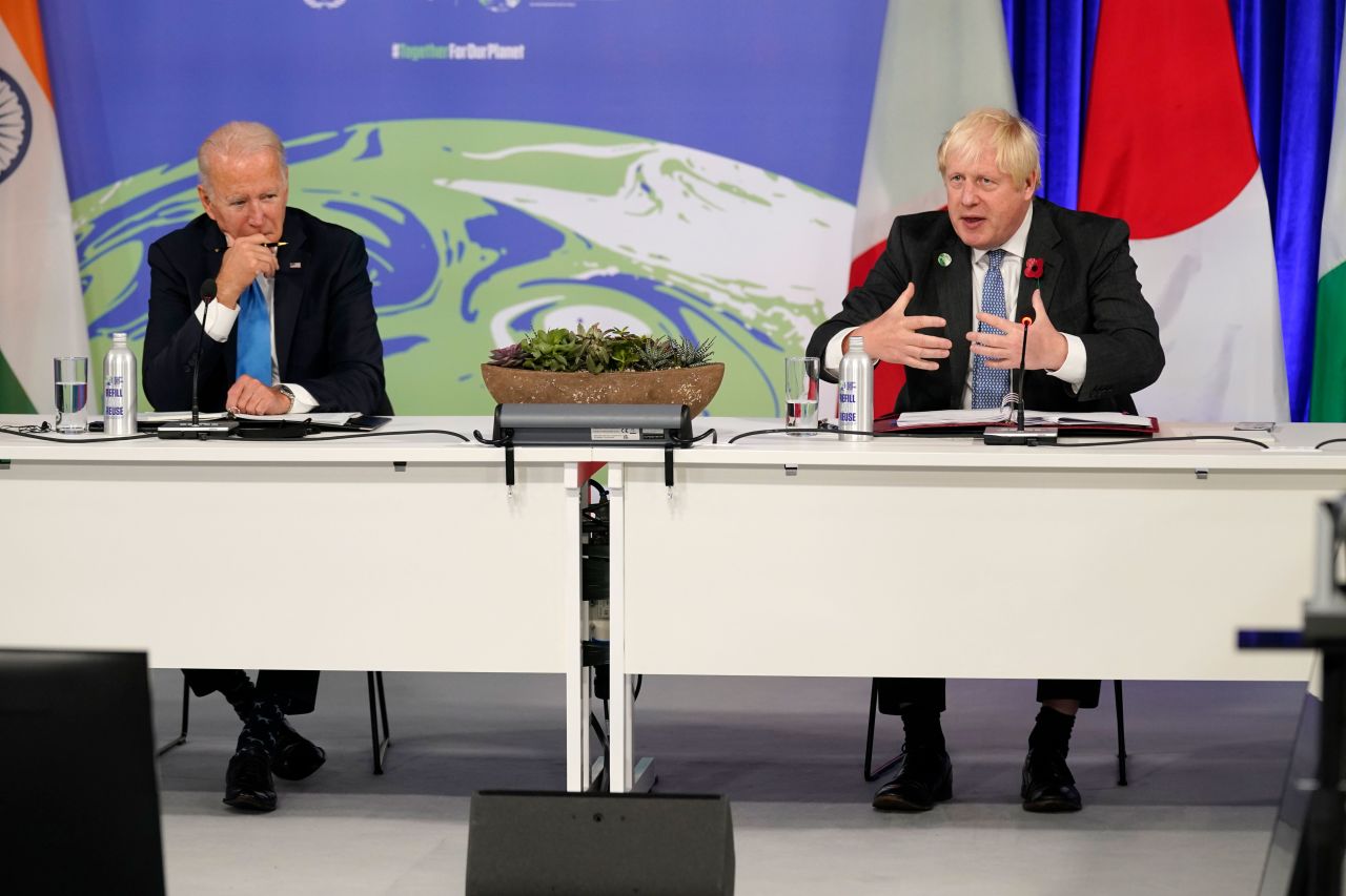 UK Prime Minister Boris Johnson speaks during a meeting at COP26 in Glasgow, Scotland, on November 2, as US President Joe Biden listens.