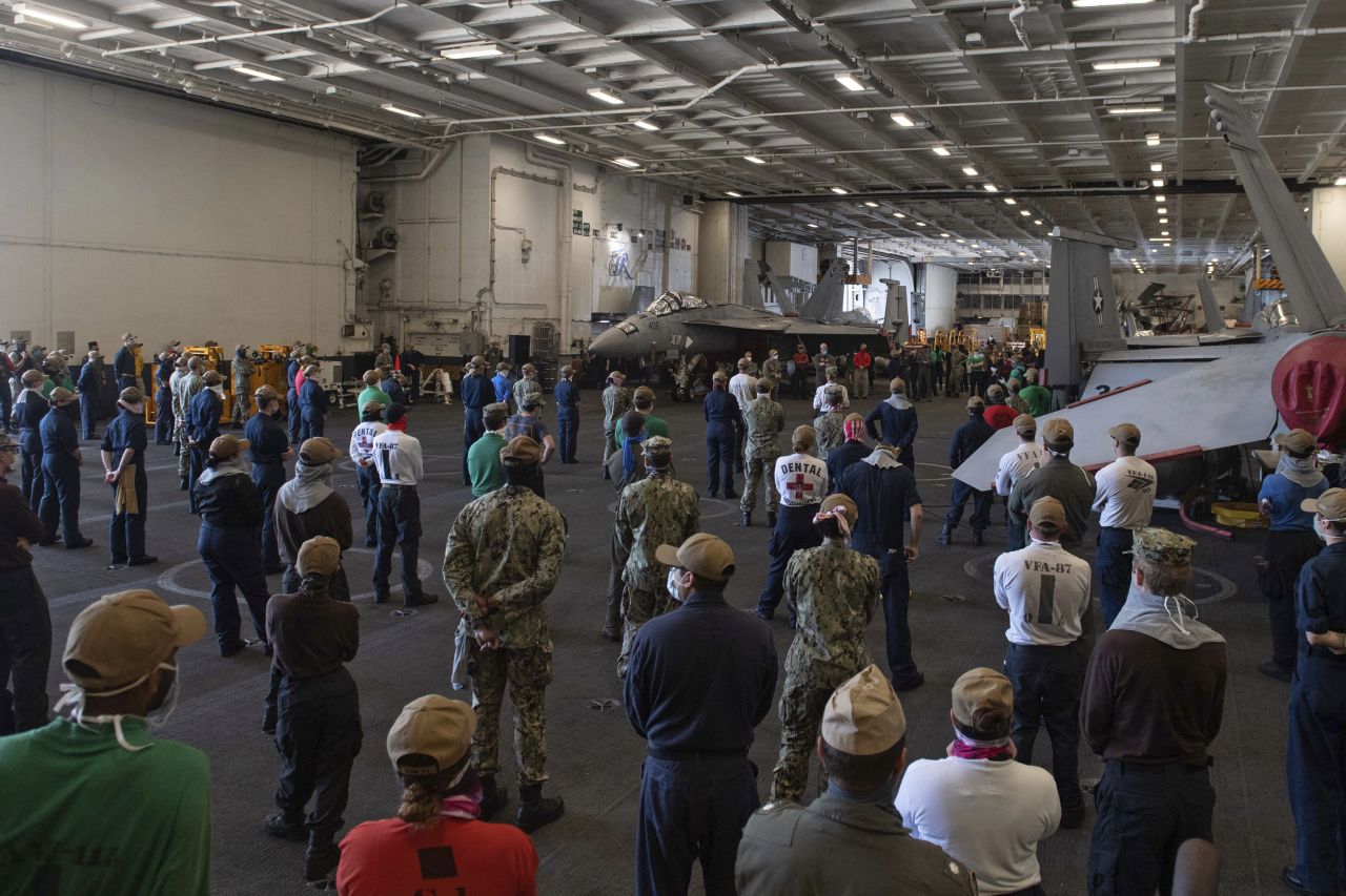 In this photo taken on April 7 and provided by the US Navy, sailors and staff assigned to the aircraft carrier USS Theodore Roosevelt listen as Vice Adm. William Merz, commander of the US 7th Fleet, answers questions during a visit to the ship at Naval Base Guam.