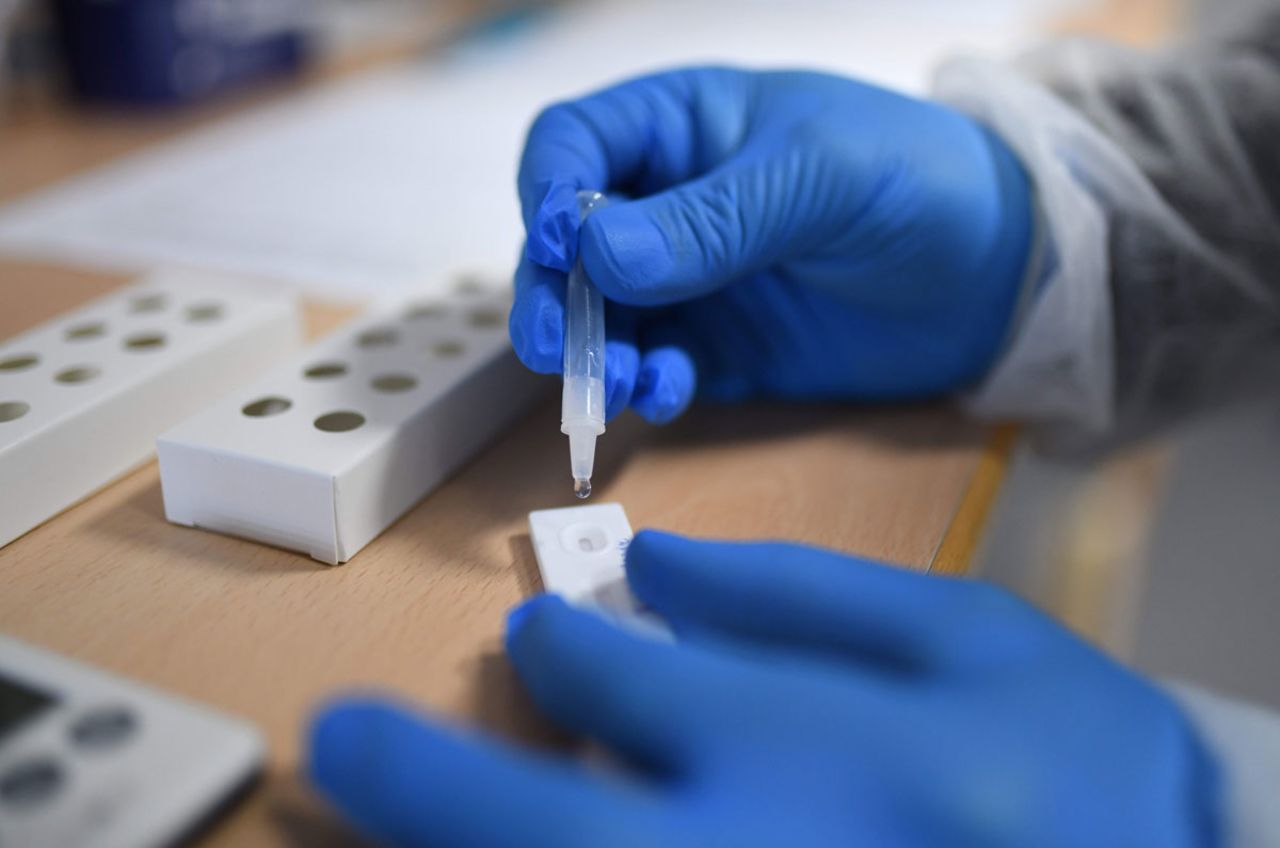 A medical assistant processes a sample from a Covid-19 rapid antigen test at a senior nursing home in Froendenberg, Germany on January 22.