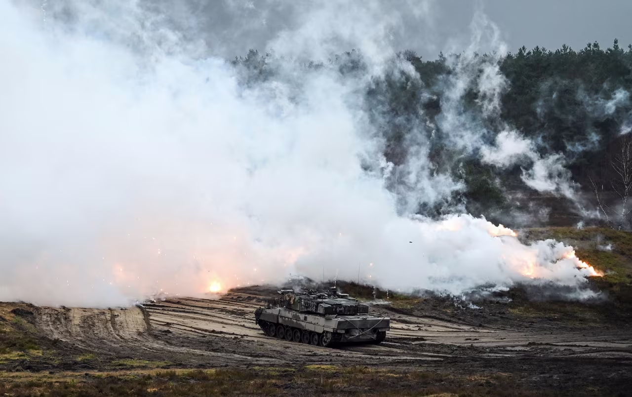 A Leopard 2 A6 tank of the German Army's Tank Battalion 203 shoots a smoke screen in a military training area in Augustdorf, Germany, on February 1. 