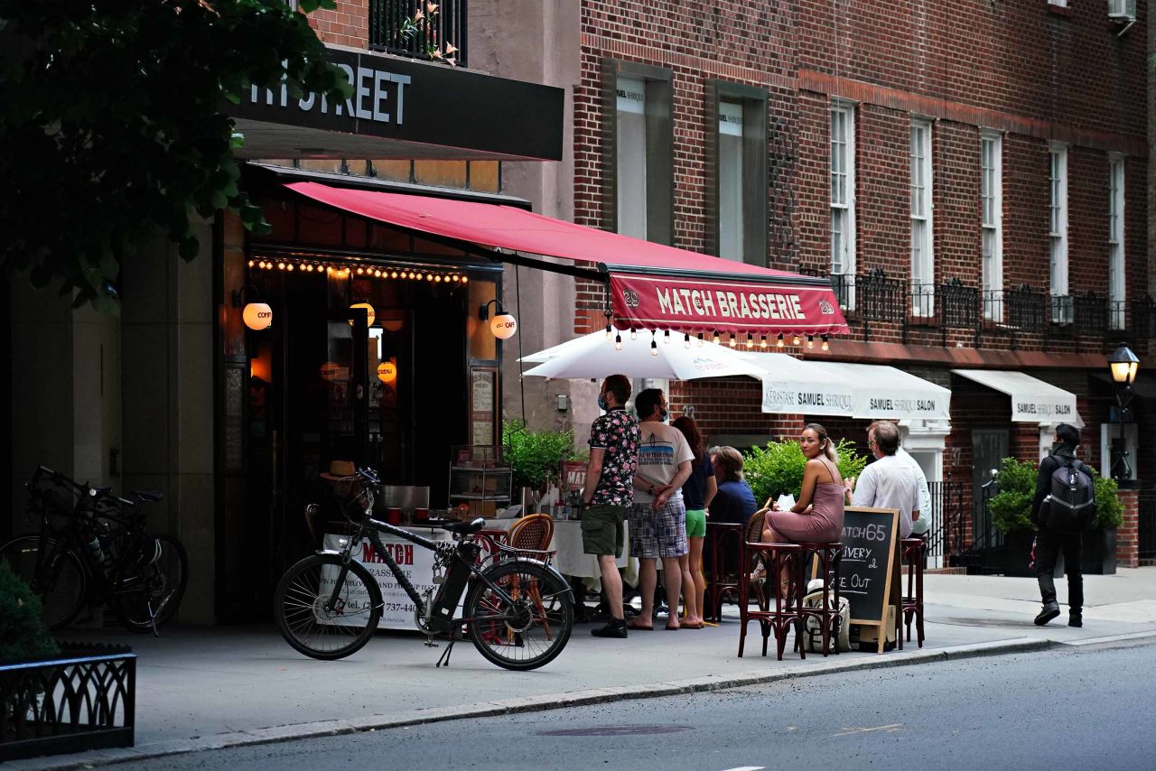 A restaurant in New York serves drinks to customers outside on June 20. 