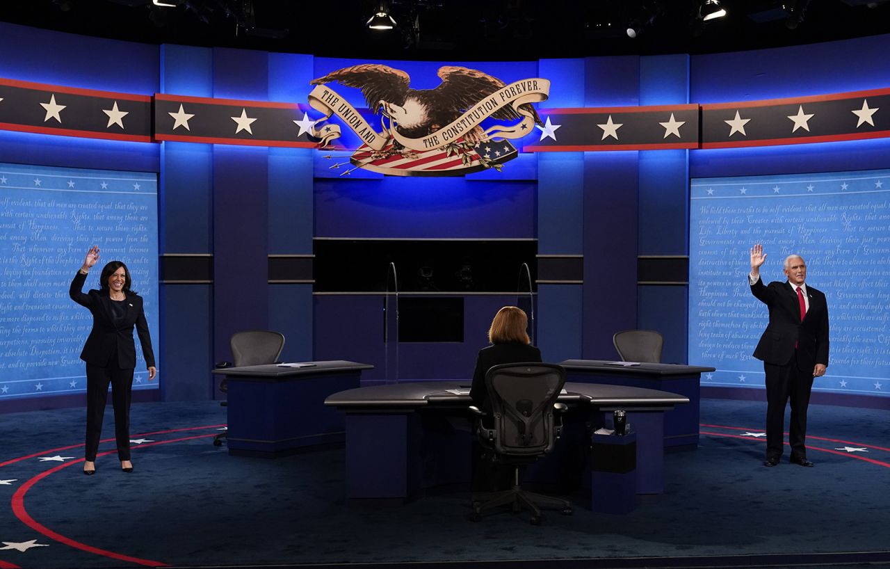 Democratic vice presidential candidate Sen. Kamala Harris and Vice President Mike Pence wave before the vice presidential debate on Wednesday, October 7, at Kingsbury Hall on the campus of the University of Utah in Salt Lake City.