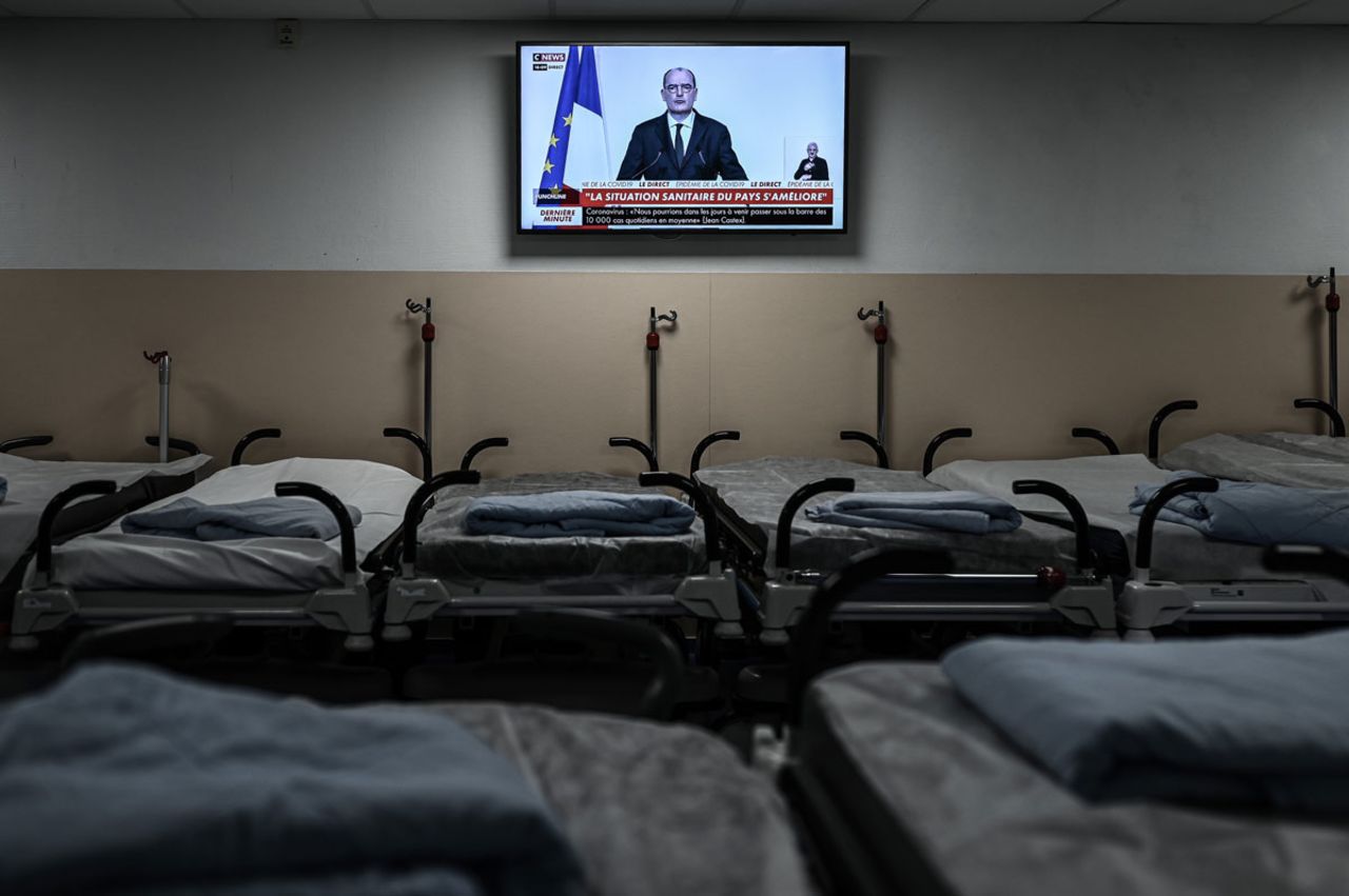 A television above empty beds at the Polyclinique Jean Villar private hospital in Bruges, France broadcasts French Prime Minister Jean Castex’s press conference outlining the country’s plans for deploying the coronavirus vaccine, on December 3.