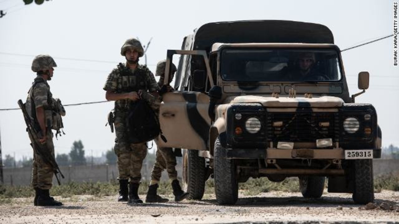 Turkish soldiers stand guard on the Turkey-Syria border on Wednesday.