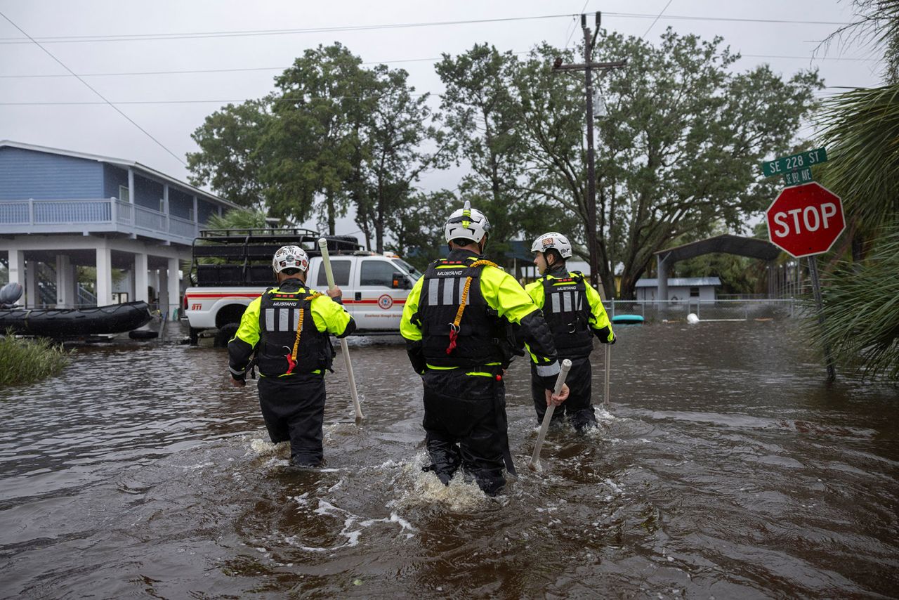 Miami Search and Rescue Fire Department personnel search for people in flooded houses as Debby affects the gulf coast in Suwannee, Florida, on August 5.