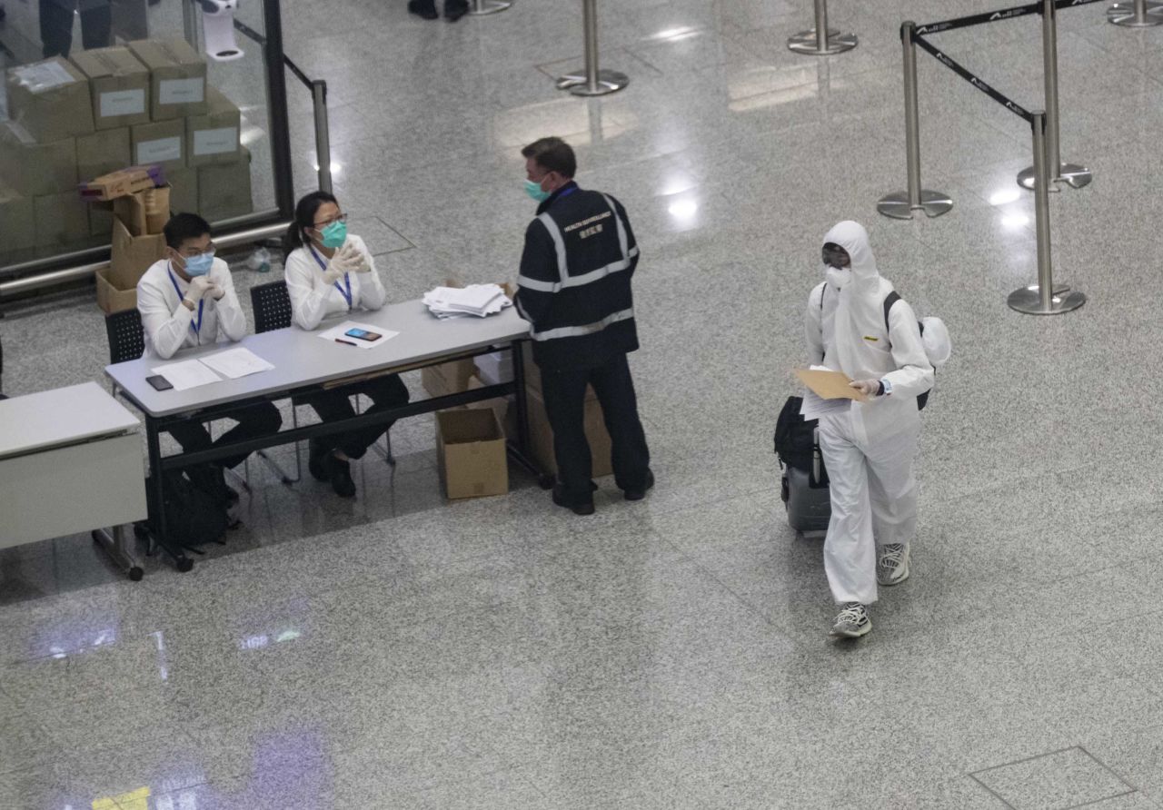 A passenger wearing a protective suite arrives at Hong Kong International airport on March 24.