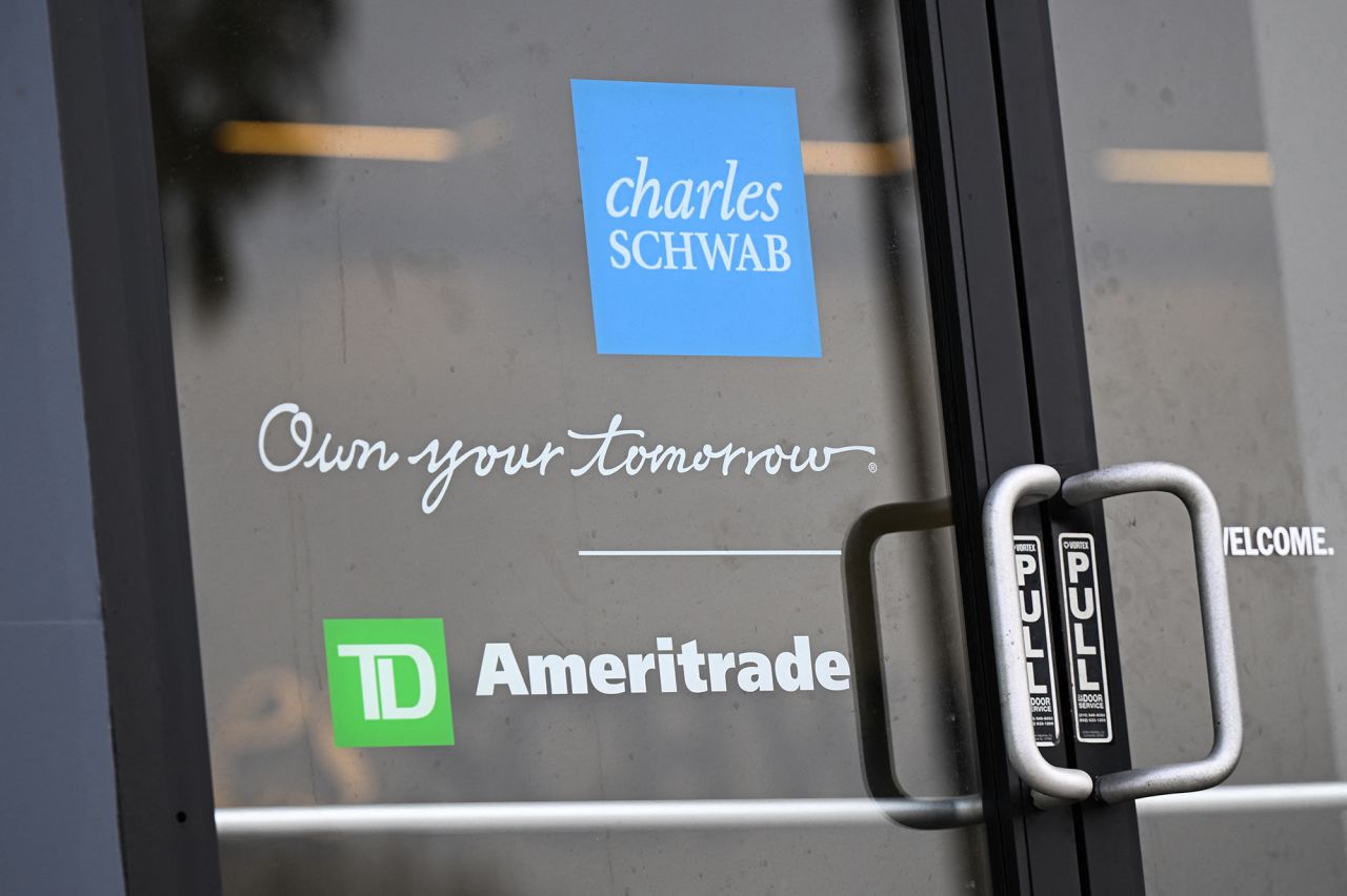 The Charles Schwab and TD Ameritrade logos are displayed on the door of a Charles Schwab Corporation branch in Torrance, California, on March 13, 2023. 