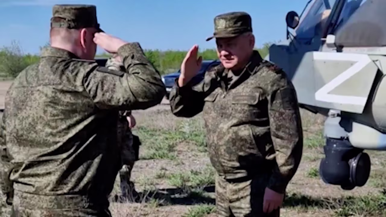 Russian Defense Minister Sergei Shoigu salutes a troop before inspecting military equipment and troops on Friday in Russia's southern military district according to Russian military. 