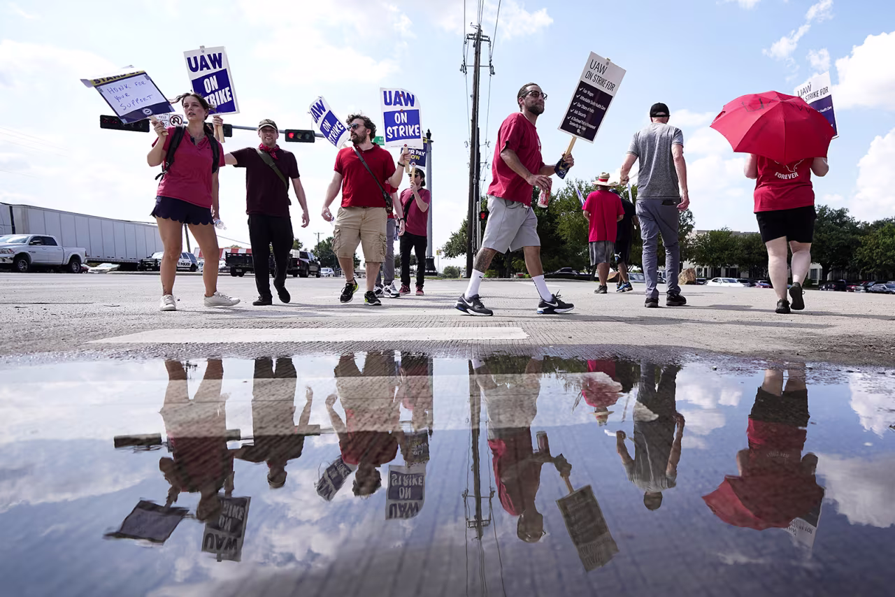 UAW union members picket on the street in front of a Stellantis distribution center, Monday, Sept. 25 in Carrollton, Texas.