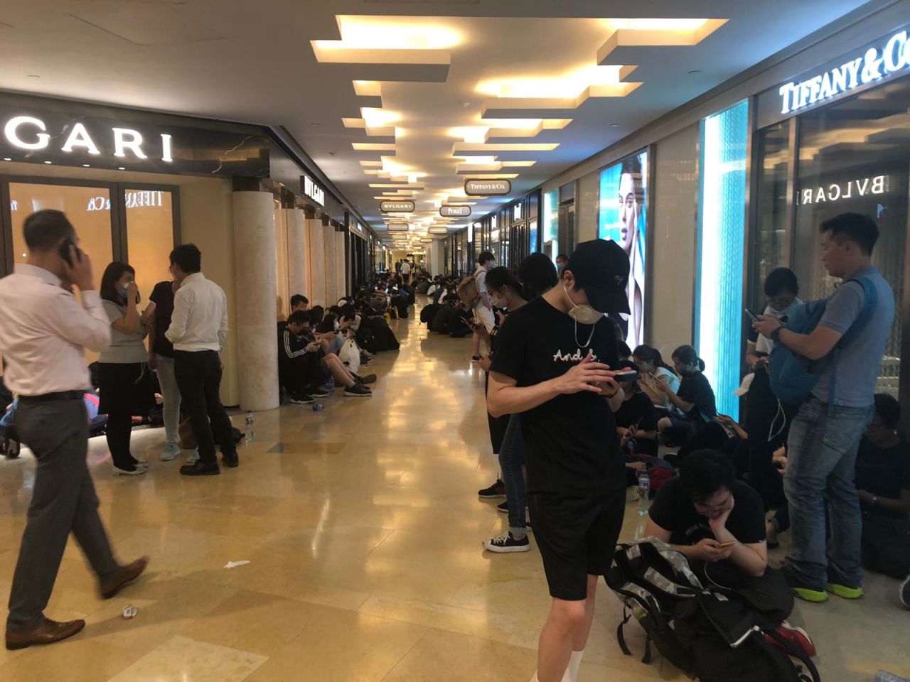 Protesters take shelter outside Tiffany & Co. at Pacific Place mall. 