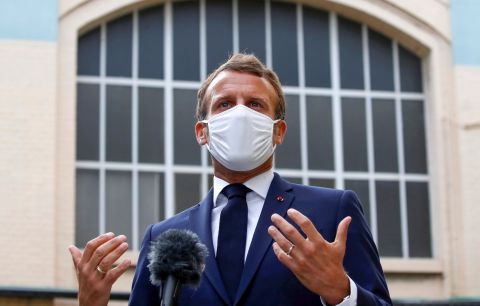 French President Emmanuel Macron speaks to the media as he visits a site of pharmaceutical group Seqens on August 28 in Paris, France.