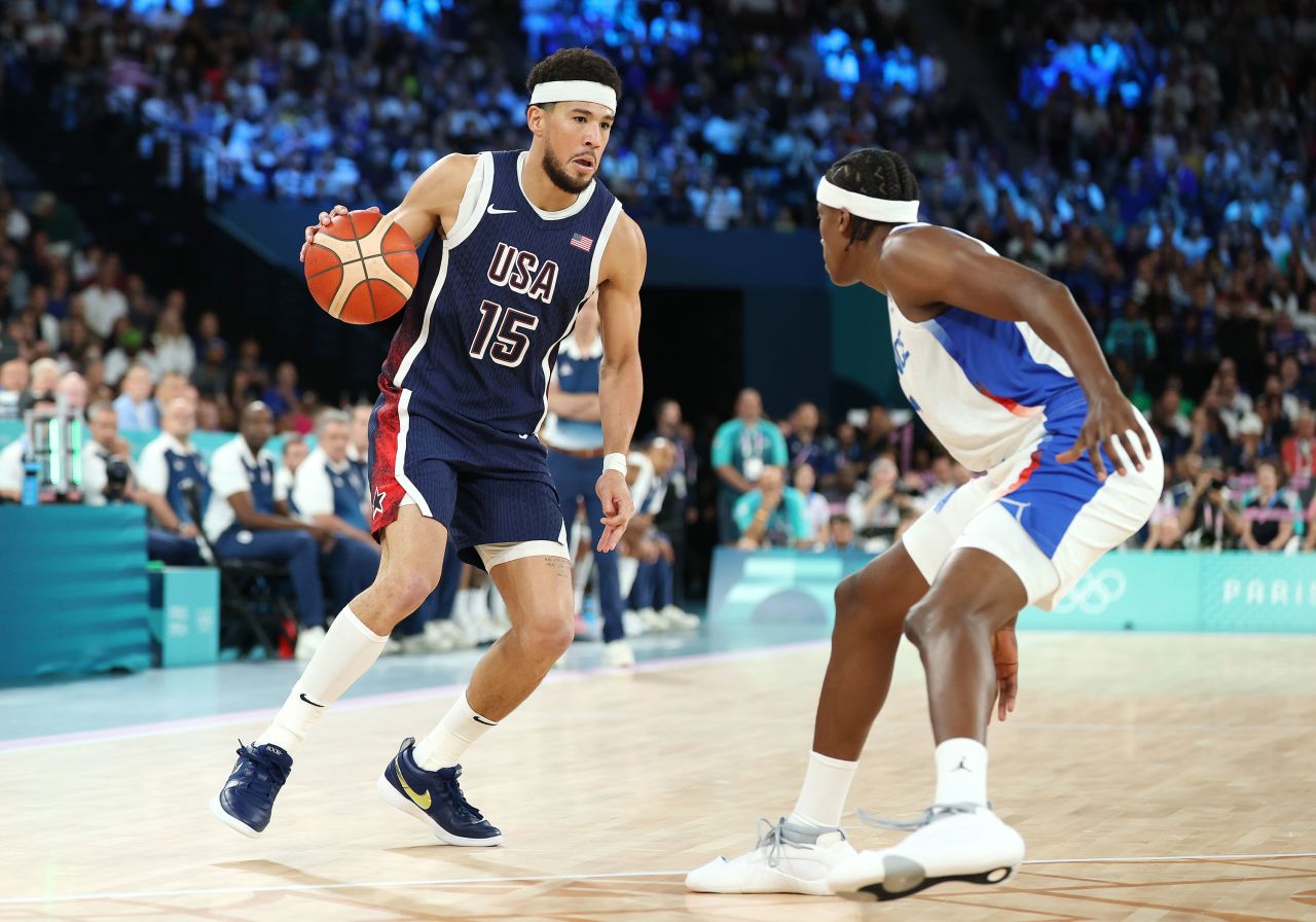 Team USA's Devin Booker drives past Frank Ntilikina of France during the first quarter Saturday. 