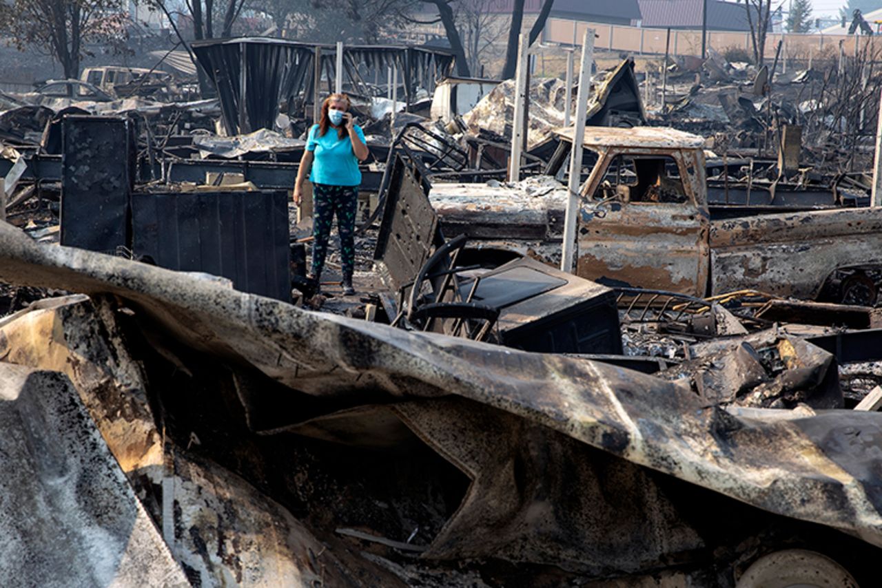 Heather Marshall talks to her mother as she stands by the ruins of her home at Coleman Creek Estates mobile home park in Phoenix, Oregon, Thursday, September 10, after a wildfire swept through. The Marshalls lived at the park for 21 years. 