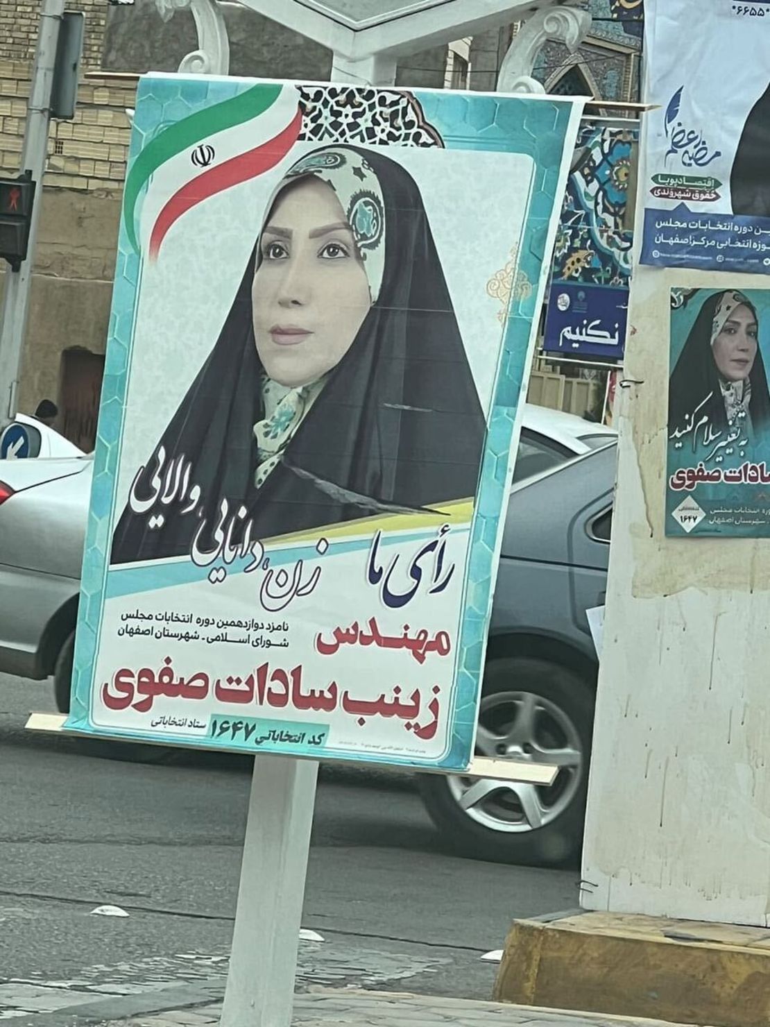 An election poster for a female parliamentary candidate apparently plays on the 'Woman-Life-Freedom' protest slogan, replacing it with 'Woman-Wisdom-Greatness' in Isfahan, Iran on February 24.