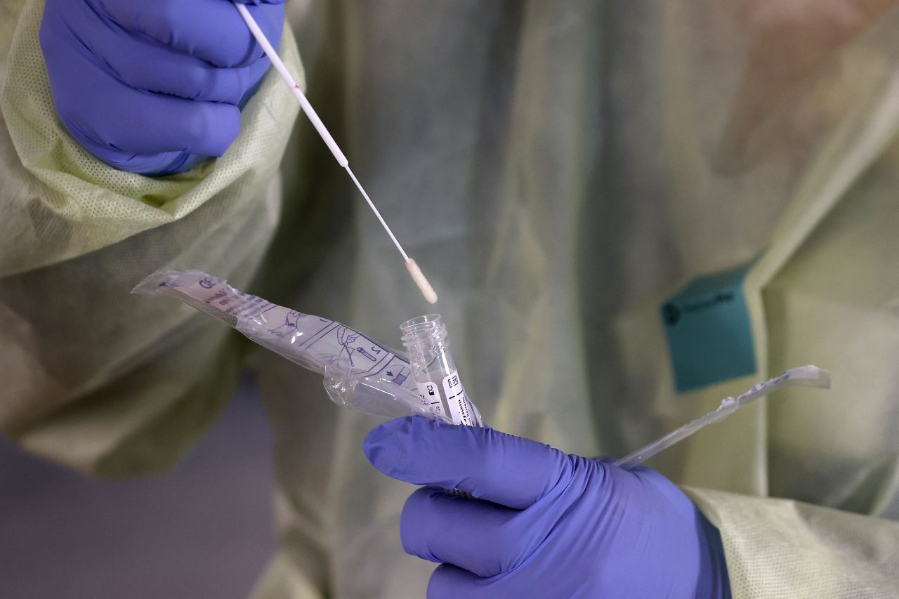 A medical professional handles a sample from a person tested for the coronavirus at a drive-thru station at a hospital in Westminster, Maryland, on March 16.