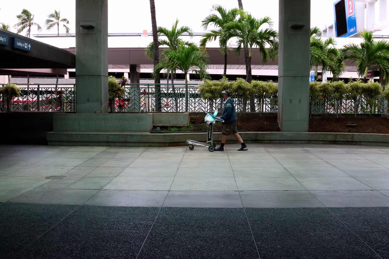In this April 21 photo, a man pushes a cart at the international airport in Honolulu. 